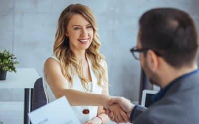 A handshake between two people in the office to illustrate internal mobility.