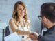 A handshake between two people in the office to illustrate internal mobility.